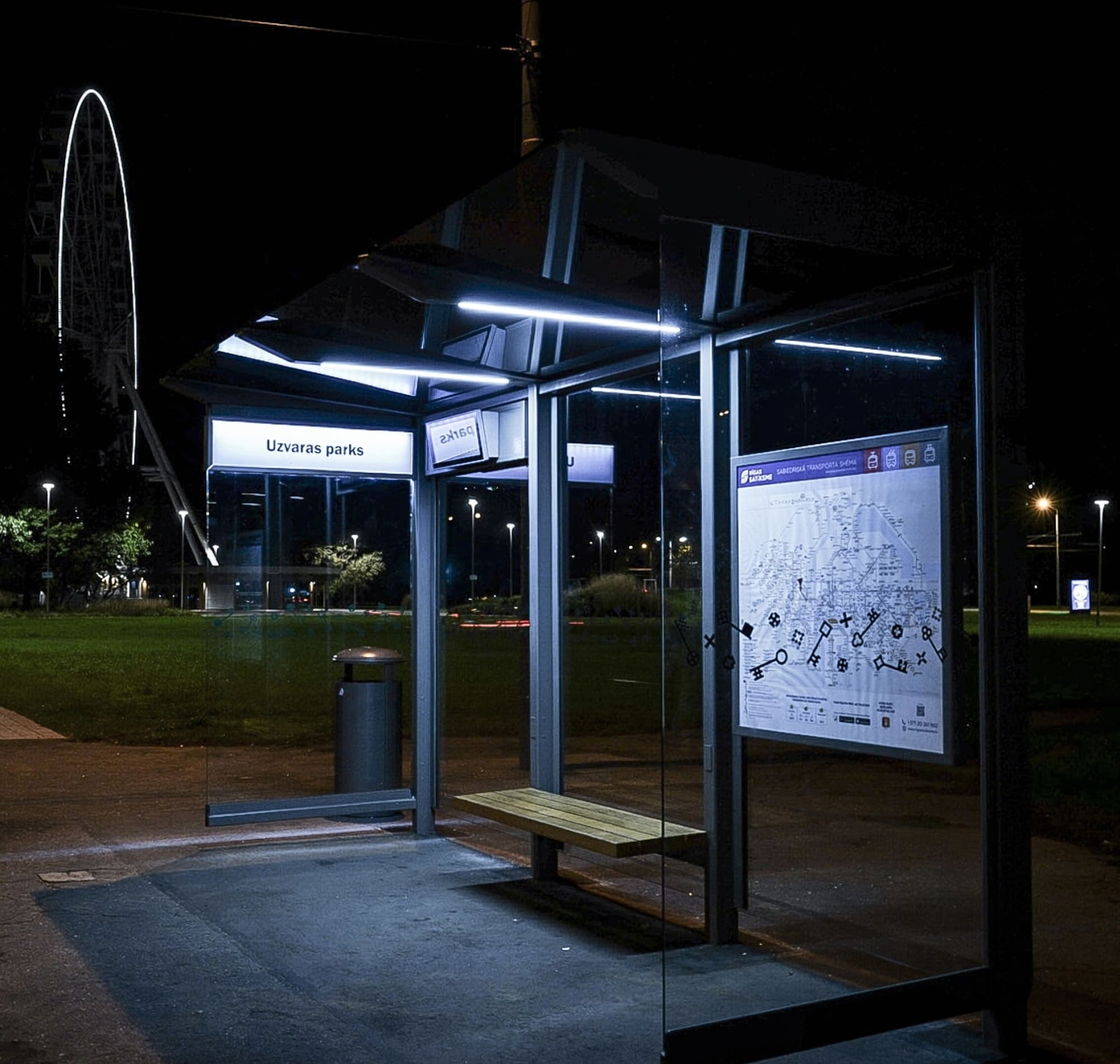 Modern bus stop with bench and information board at night